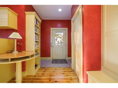 Entering the home, you are welcomed into a large kitchen and family room, with views of the expansive property, and access to a private office. 