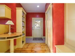 Entering the home, you are welcomed into a large kitchen and family room, with views of the expansive property, and access to a private office. 