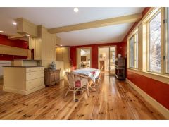 Family room, with views of the expansive property, and access to a private office
